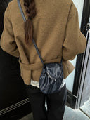 Reco Clam Shell crossbody bag in cyan blue oil-waxed cowhide with a kiss-lock clasp and natural pleats.