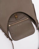 Reco Halston Umber bag in Togo calfskin with a textured finish and gold hardware. Features a crescent silhouette and zip pocket.