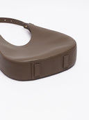 Reco Halston crescent shoulder bag in raw umber Togo calfskin with a textured grain and minimalist silhouette.