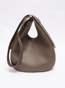 Reco Halston crescent shoulder bag in raw umber Togo calfskin with a textured, minimalist slouchy silhouette.