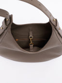 Reco Halston crescent shoulder bag in raw umber Togo calfskin with a textured grain and gold-toned interior hardware.