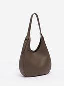 Reco Halston crescent shoulder bag in raw umber Togo calfskin leather with a minimalist, slouchy silhouette.