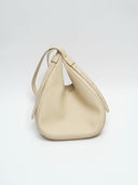 Reco Halston white shell handbag in premium Togo calfskin with a minimalist, slouchy silhouette and adjustable strap.