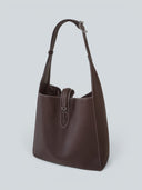 Reco Key Hobo bag in rosewood pebbled leather with white stitching and a signature key closure. Adjustable shoulder strap.