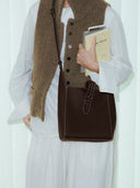 Reco Key Hobo (22) rosewood pebbled leather shoulder bag with key closure and contrast stitching.