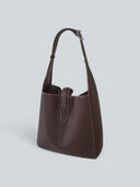 Reco Key Hobo (22) rosewood pebbled leather shoulder bag with white stitching and key closure.