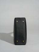 Reco L'erreur black dumpling bag base with four gold-tone protective feet on smooth Napa leather
