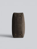 Reco L'erreur dumpling bag in Falcon Gray nubuck leather, showing the flat base with four protective metal feet.