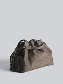 Reco L'erreur dumpling bag in Falcon Grey Nubuck leather with drawstring top and pleated detail.