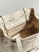 Reco L'erreur dumpling bag in Fog White pebbled Togo calfskin with a drawstring top and gold-tone interior zipper