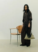 Reco Morph Boston (S) bag in beige canvas with dark leather trim, worn by a model.