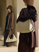 Reco Morph Boston (M) bag in beige canvas with brown leather trim, worn as a tote or triangle hobo.