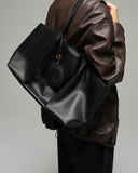 Reco Ordo black Napa leather dumpling tote bag with deep pleats and leather tags.