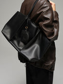 Reco Ordo black Napa leather dumpling tote bag with deep pleats and leather tags.