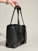 Reco Ordo black Napa leather dumpling tote bag with deep pleats and hanging tags.