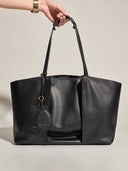Reco Ordo black Napa leather dumpling tote bag with deep-pleated front and hanging tag.