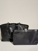 Reco Ordo black Napa leather dumpling tote with matching pouch. Features deep pleats and a relaxed drape.