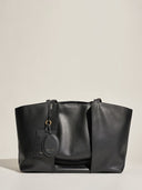 Reco Ordo black Napa leather dumpling tote bag with deep pleats and two hanging tags.