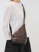 Reco Pottery Jar crossbody bag in ebony red oil-waxed full-grain cowhide leather with a sculptural design and hand-stitched seams.