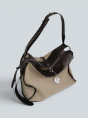 Reco Wander (L) bag in acorn canvas and dark brown leather with a compass charm and flying-tail zipper.