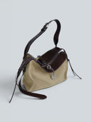 Reco. Wander bag in ebony sand suede and dark brown leather with compass charm and flying-tail zipper.